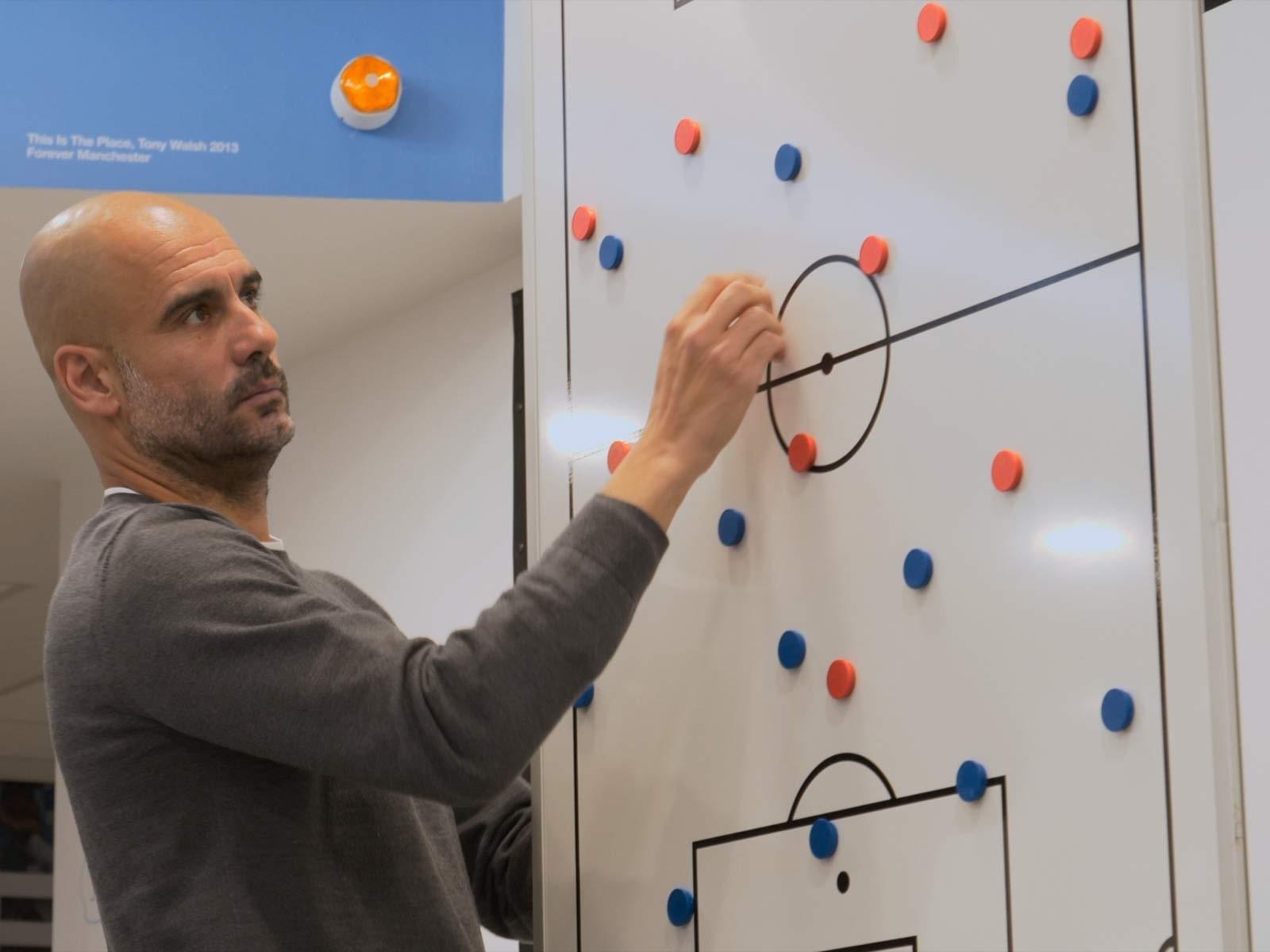 Pep Guardiola explaining tactical concepts about offensive transitions to his players.